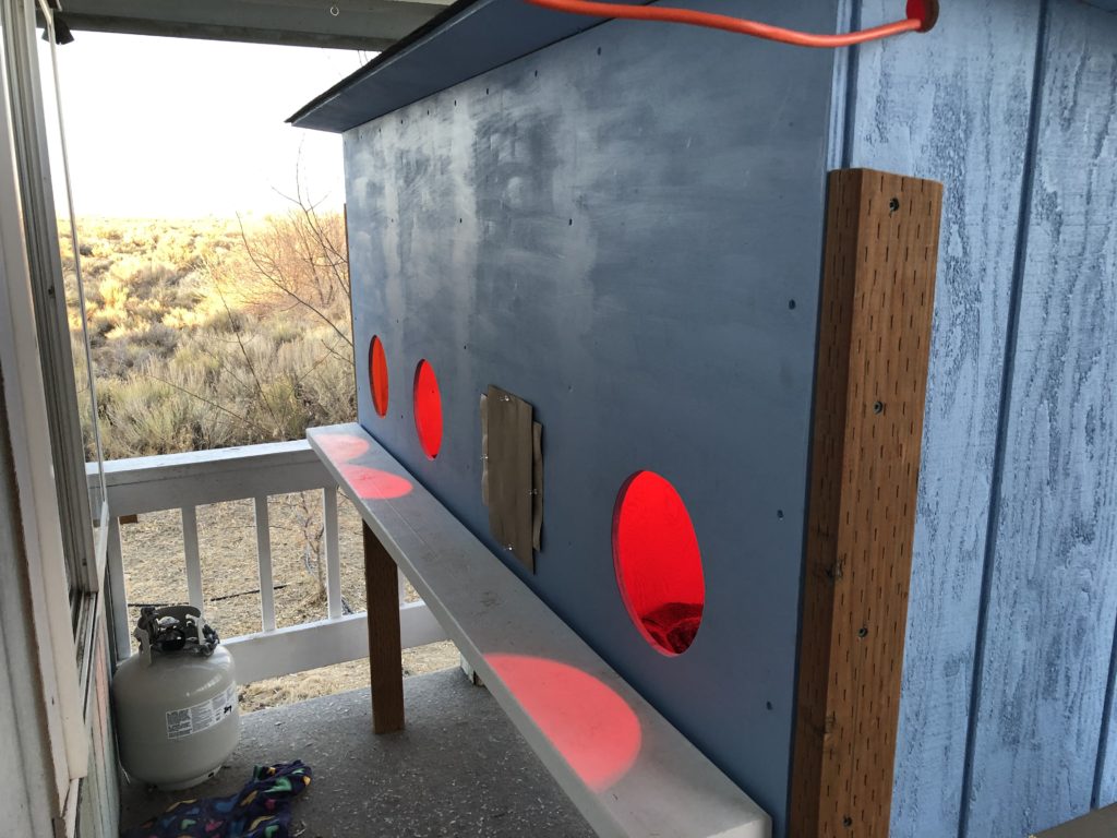 Shows the completed shelter on the front porch with the heat lamps on.